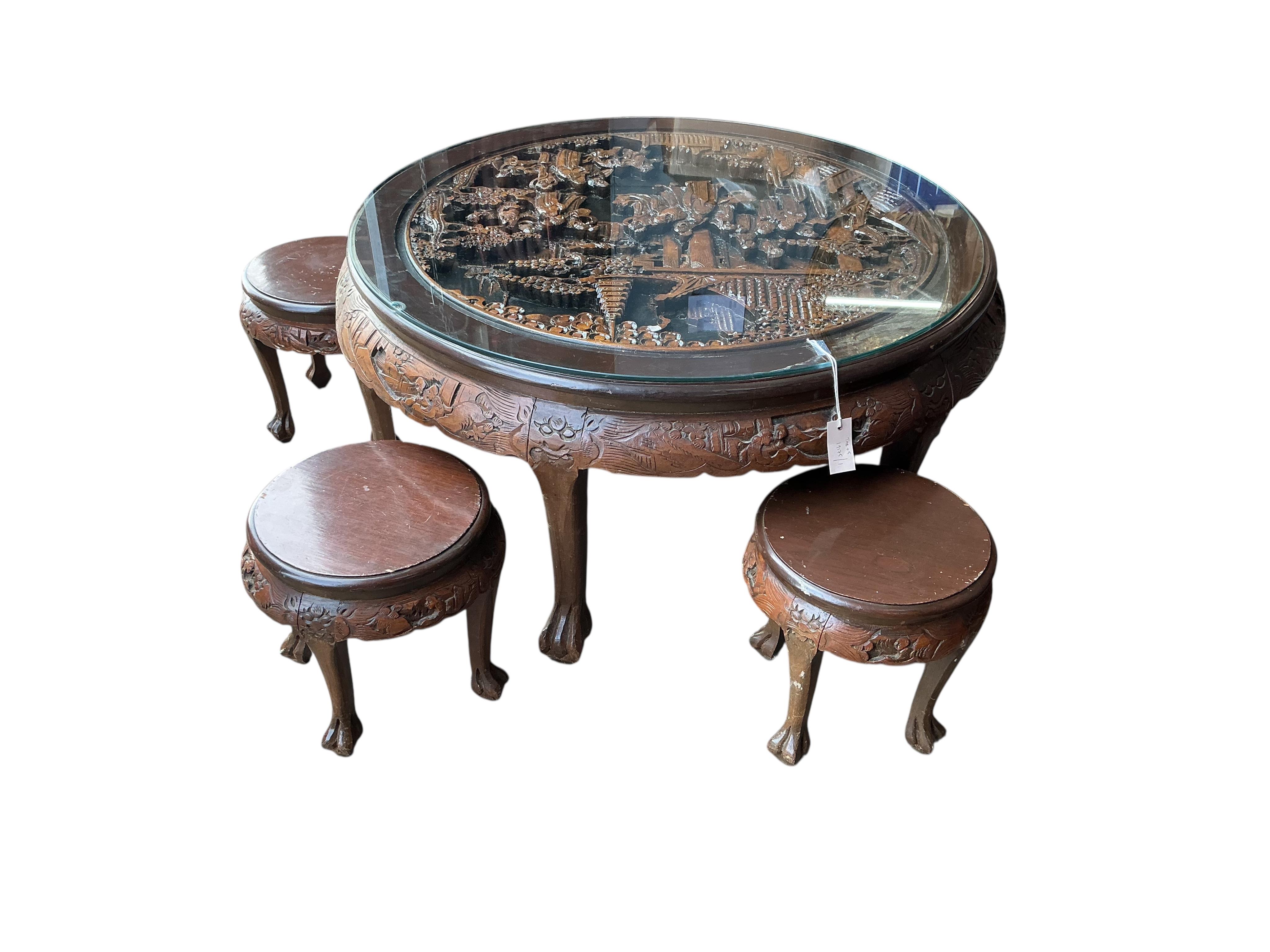 A Chinese carved hardwood circular low table, diameter 110cm, height 50cm and five stools